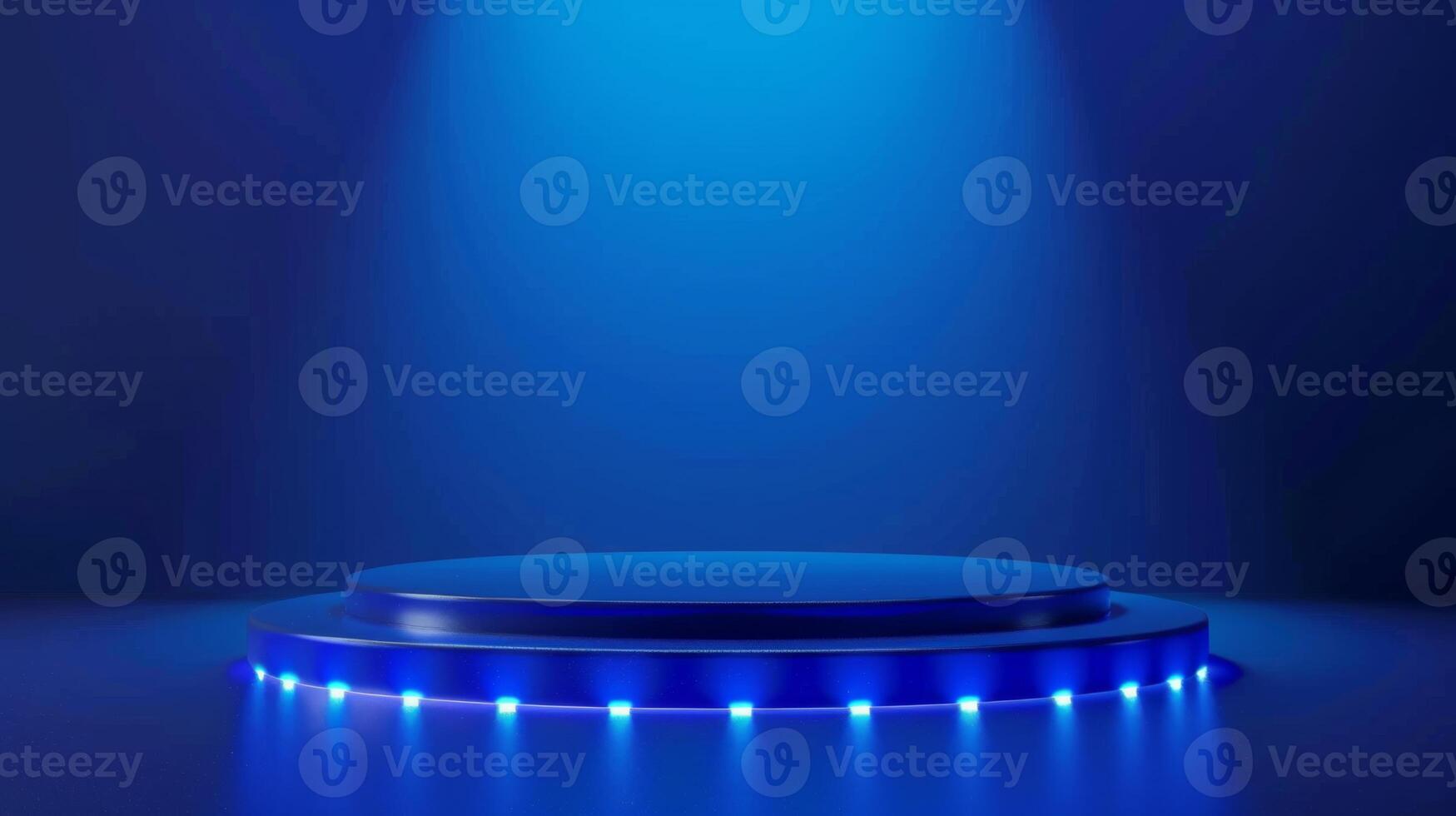 A blue-lit stage with a circular platform is illuminated by a spotlight during nighttime, surrounded by blue LEDs. photo
