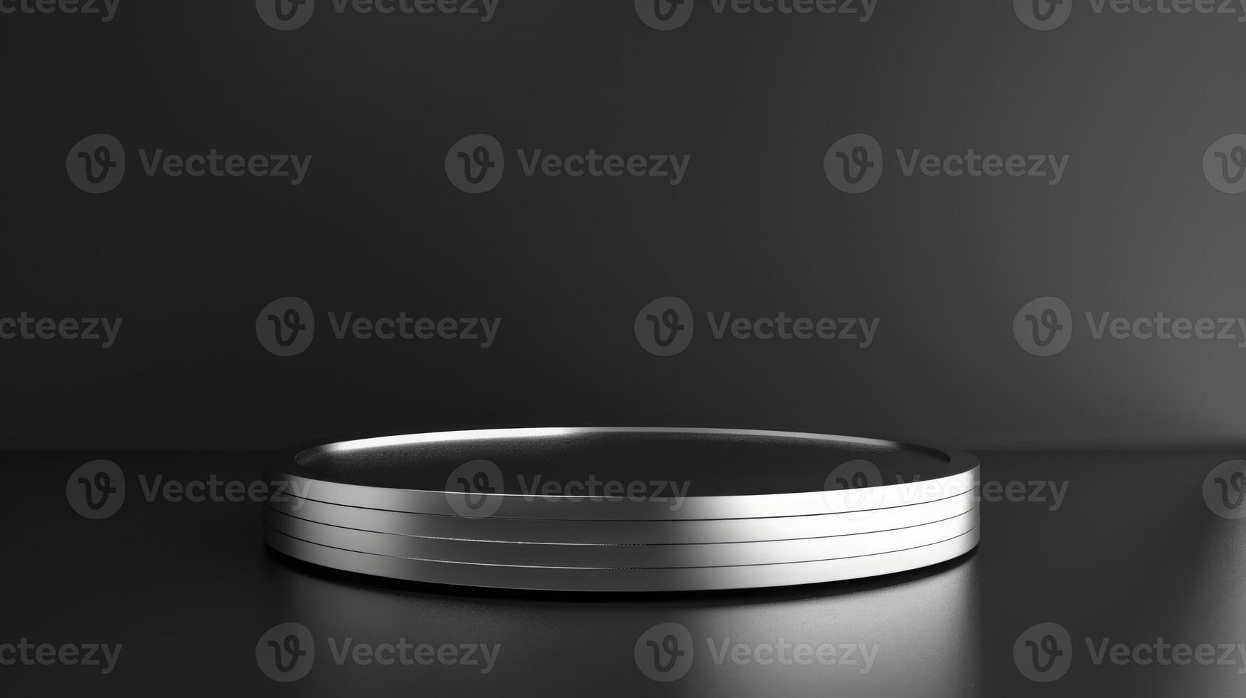 A sleek stainless steel circular platform sits in a minimalist dark setting, casting subtle reflections. The simplicity exudes a modern, futuristic aesthetic. photo