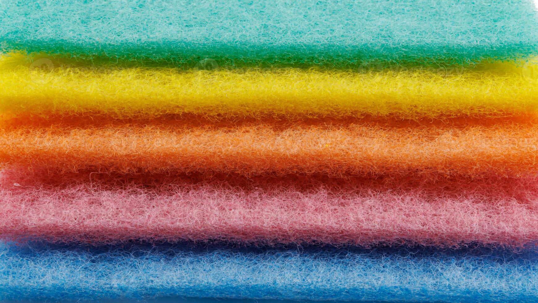 Multi-colored cleaning sponge. Background made from multi-colored cleaning cloth. photo