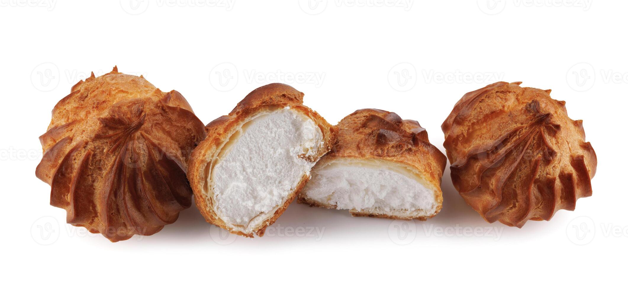 Cut in half and whole porophytroles with white cream isolated on a white background. Eclair with cream. photo