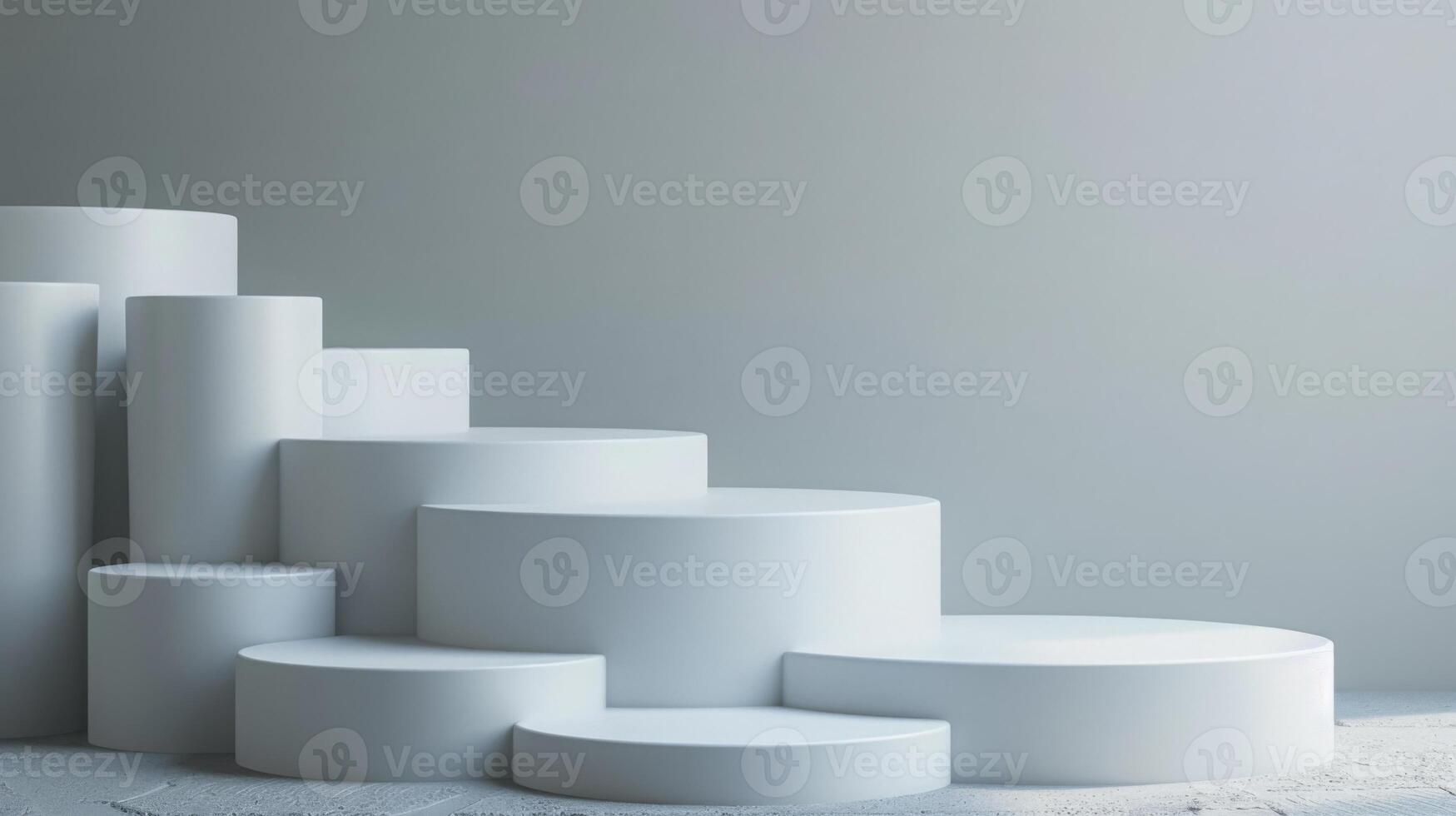 Several white cylindrical podiums of varying heights are neatly arranged in a stepped pattern against a minimalist gray background in a modern studio setting. photo
