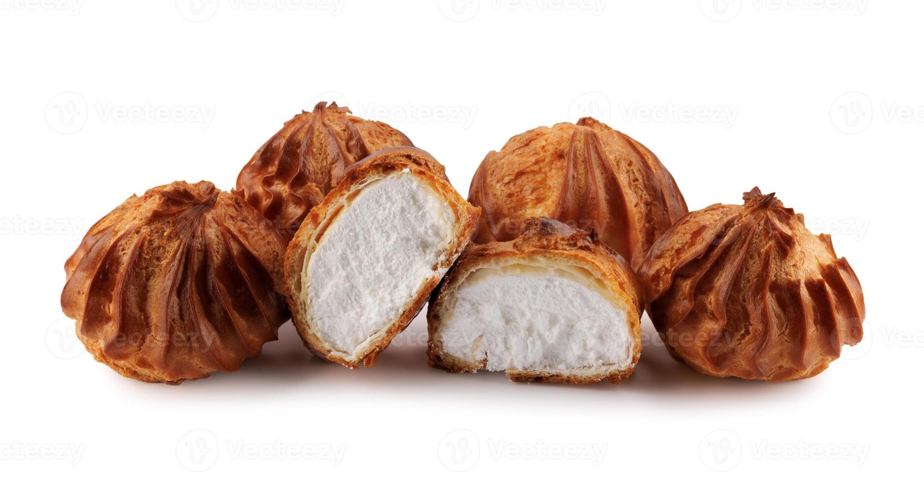 Cut in half and whole porophytroles with white cream isolated on a white background. Eclair with cream. photo