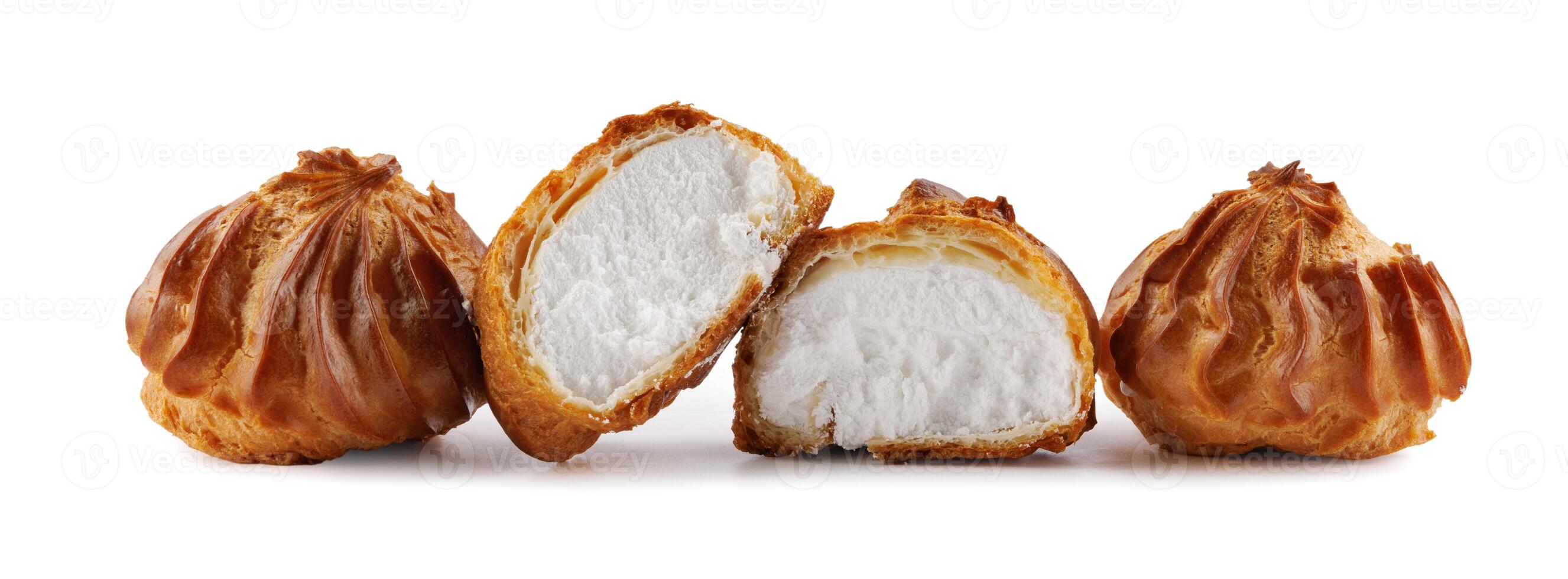 Cut in half and whole porophytroles with white cream isolated on a white background. Eclair with cream. photo
