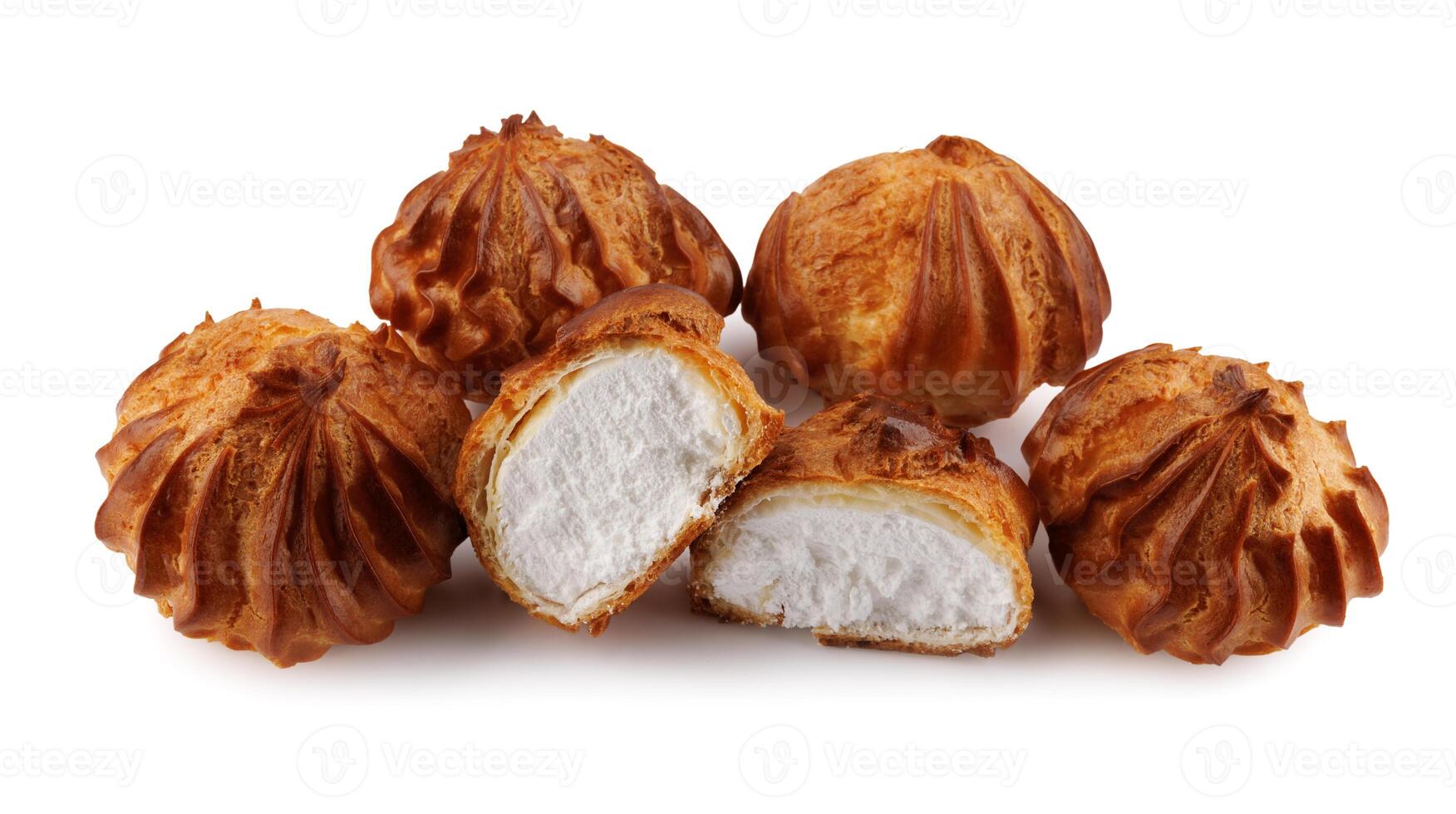 Cut in half and whole porophytroles with white cream isolated on a white background. Eclair with cream. photo
