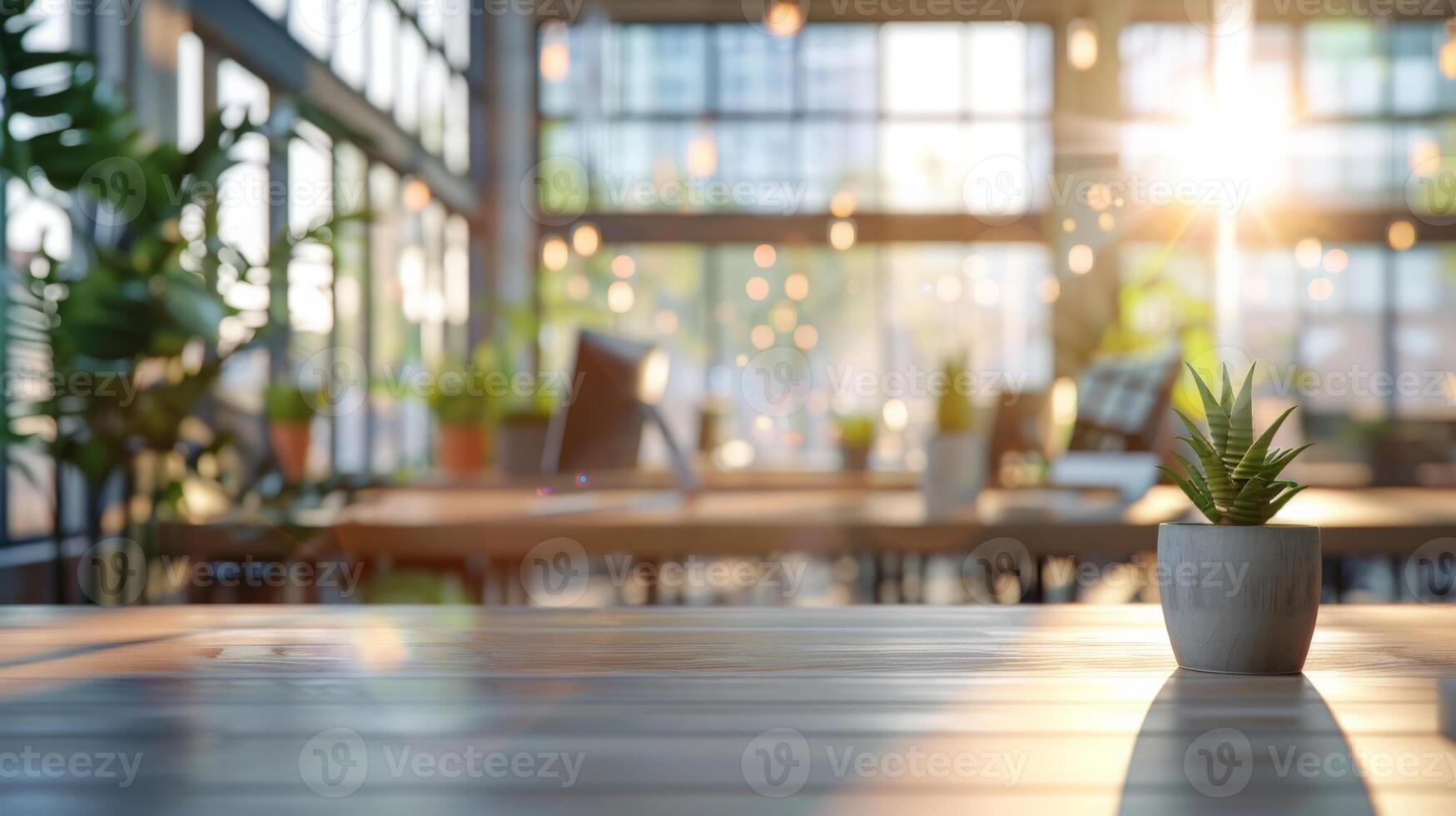 A modern co-working space bathed in morning sunlight features large windows, wooden tables, and lush indoor plants. photo