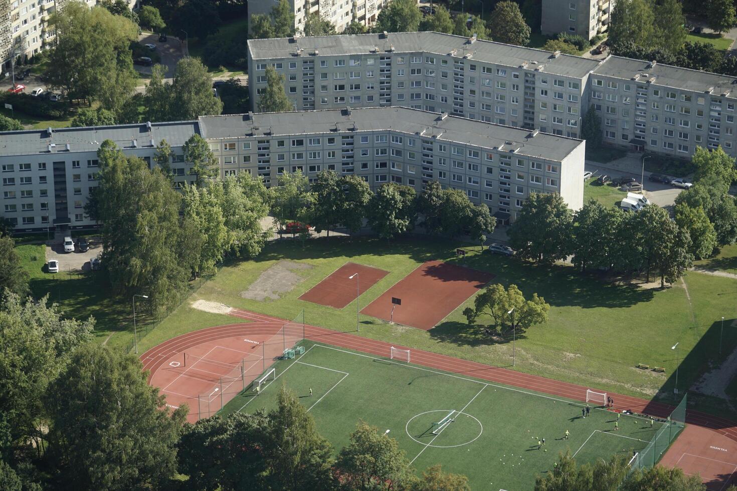 Vilnius, Lithuania - September 4th 2023 - Aerial view on soccer field and residential buildings from TV tower photo