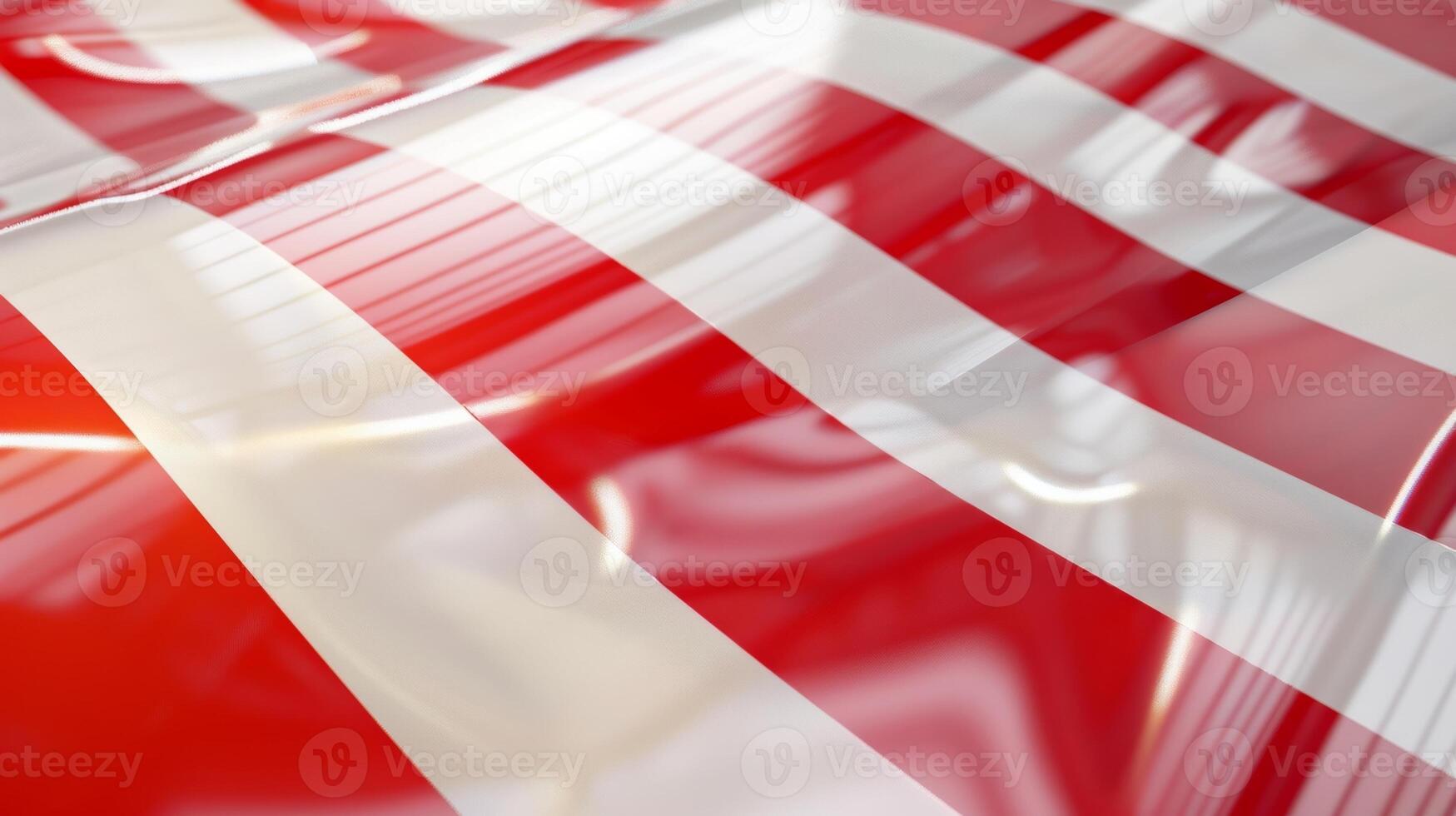 The tape features a smooth glossy surface that reflects light in different directions intensifying the bold red and white stripes that make up its distinctive pattern photo