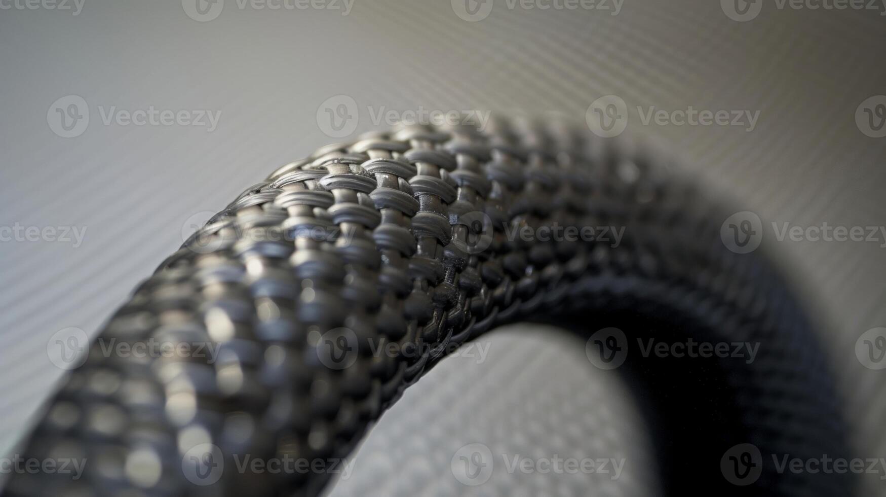 A close inspection of a rubber hoses end shows the precision molding of its curved edges and the strength of its thick walls photo