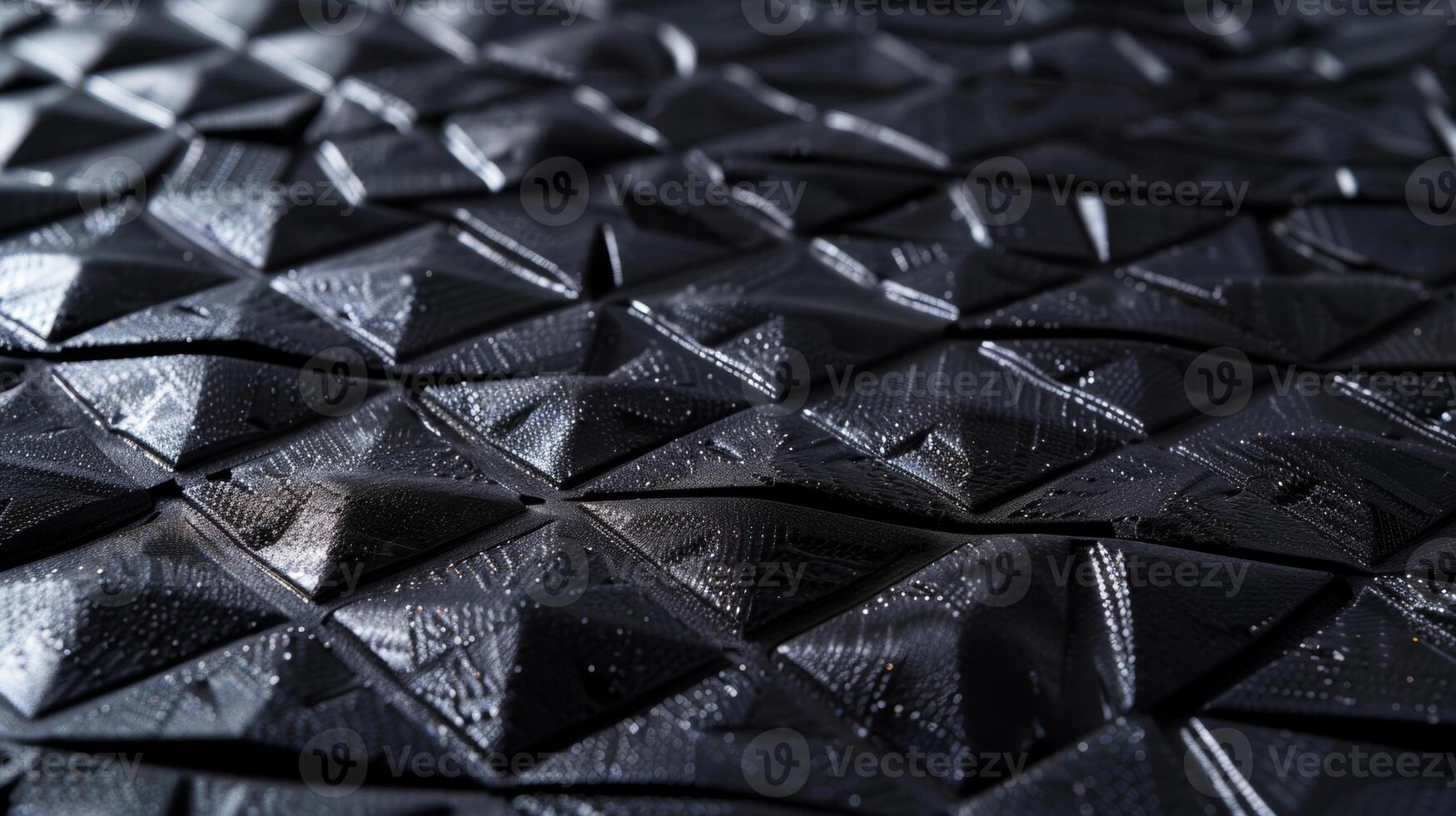 A of small triangular patterns repeating throughout the synthetic rubber providing a unique texture that enhances the materials ability to absorb shock and withstand tension photo