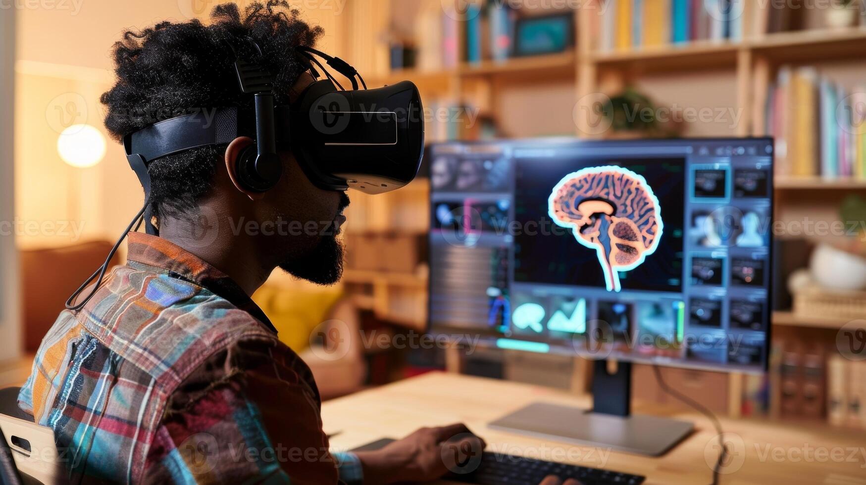 A man sitting at a desk looking at a computer screen and reviewing virtual reality therapy options for his family members brain injury photo