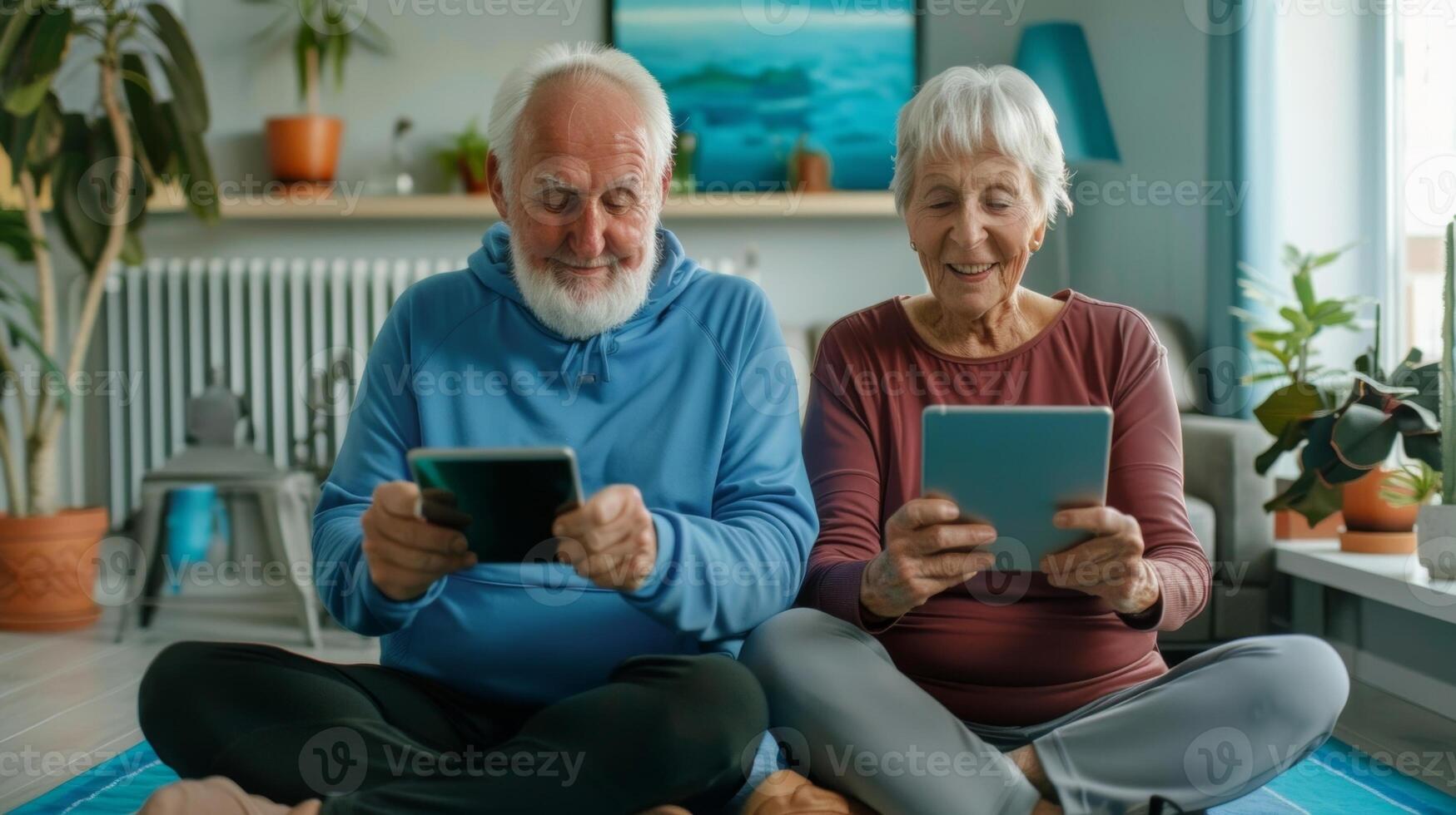 An elderly couple using a virtual workout app together on their tablet to stay active photo