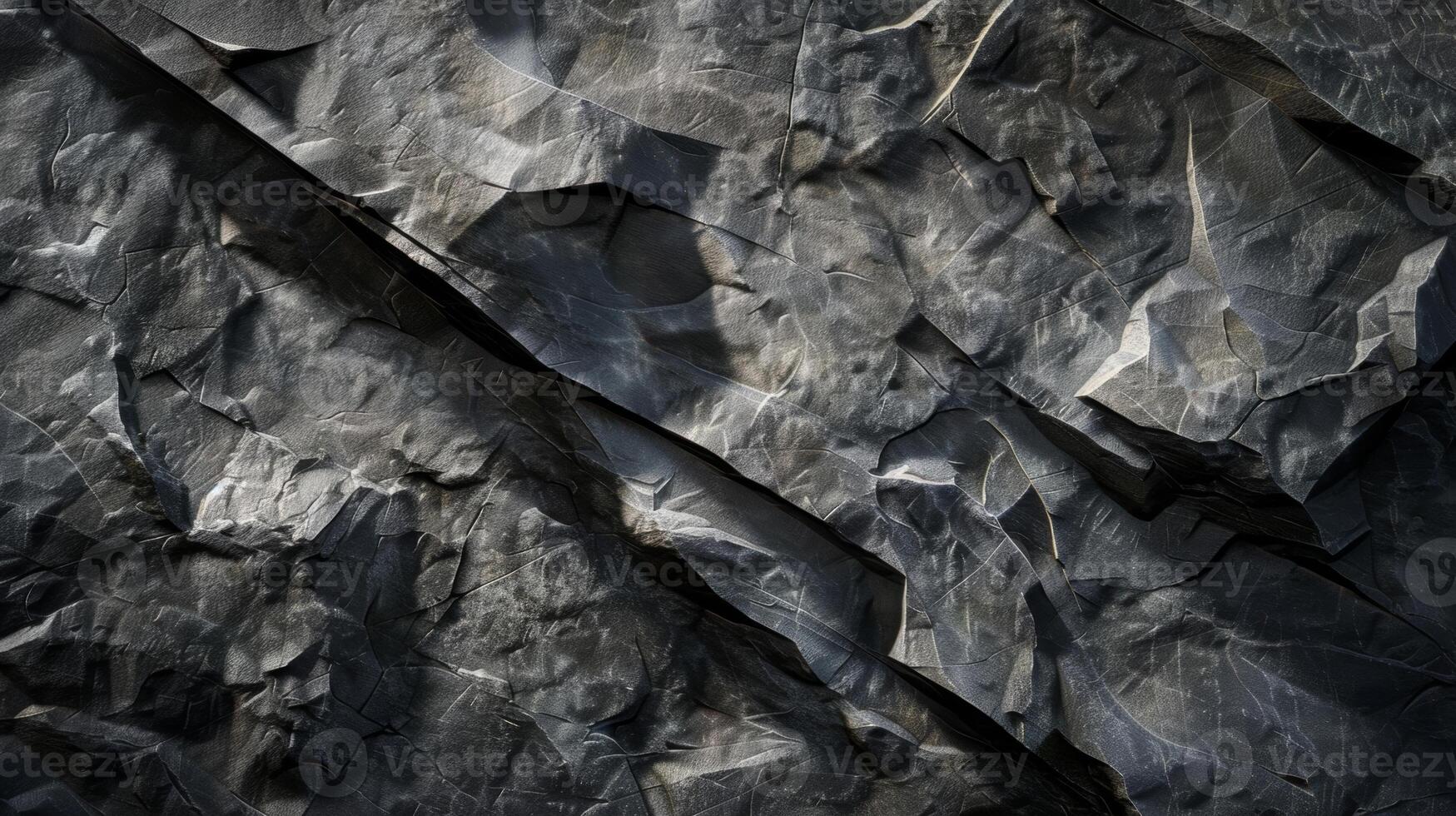 The contrast of light and shadow on the uneven surface of chiseled stone creating a mesmerizing play of textures and depths photo