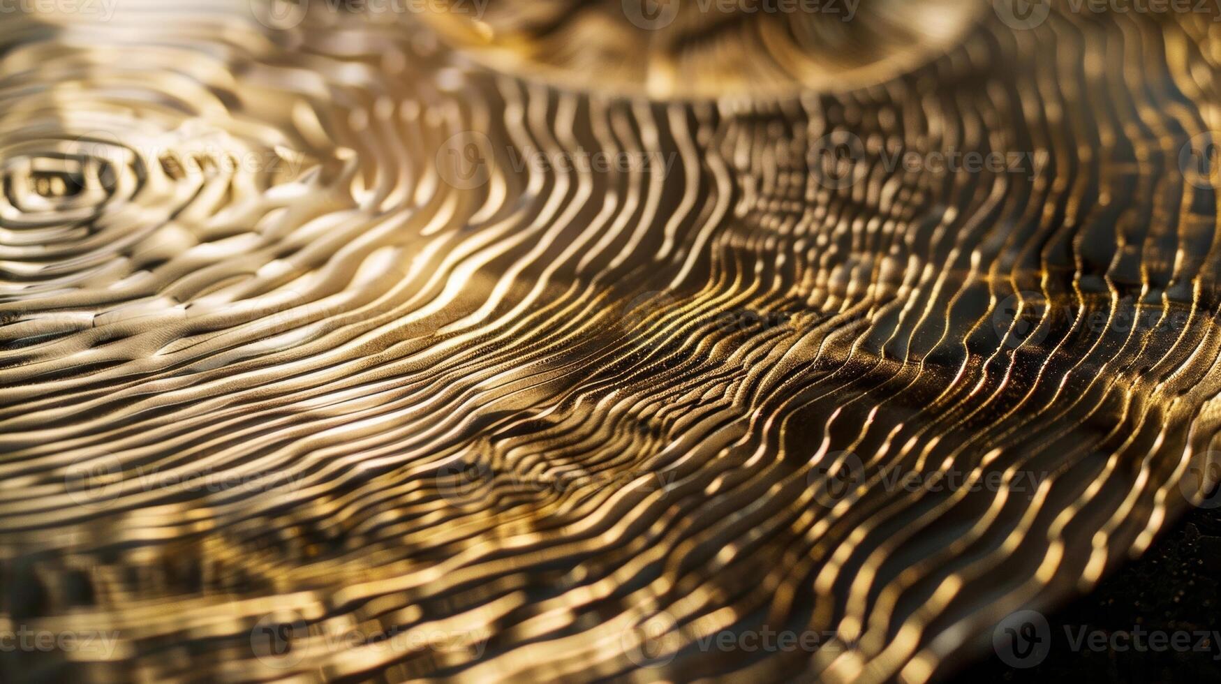 The polished brass is delicately etched with intricate patterns adding depth and texture to its gleaming surface. Faint lines and curves catch the light and create a mesmerizing effect photo