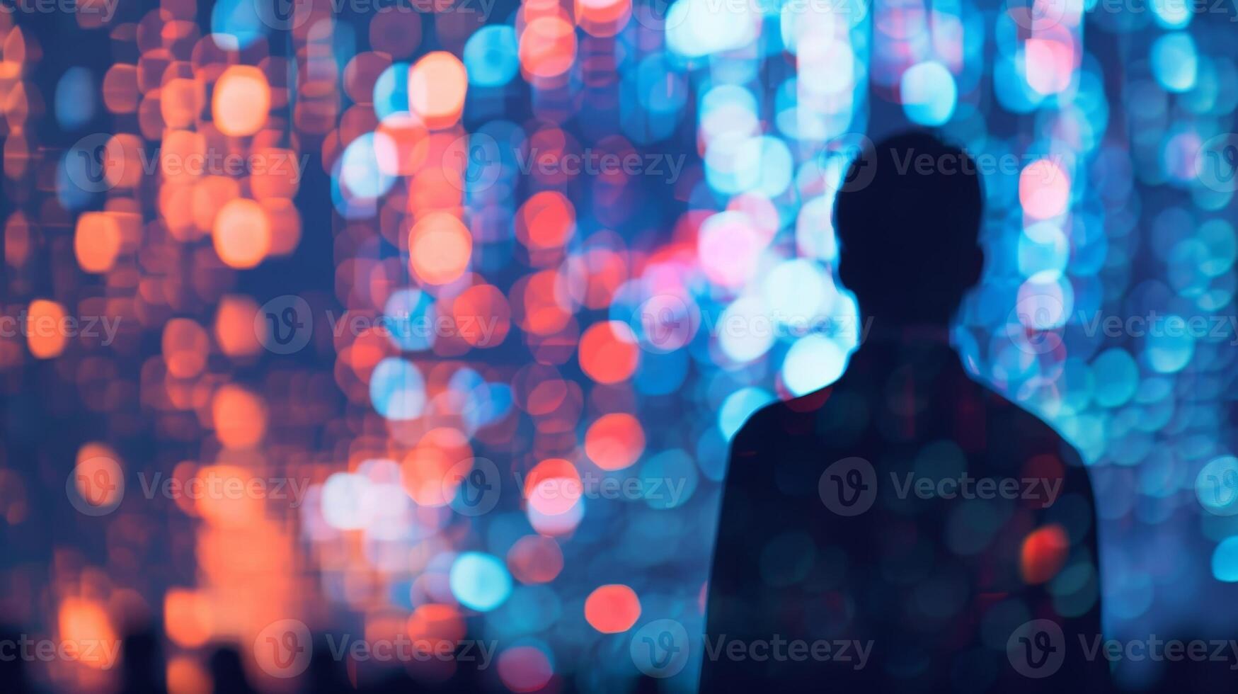 Vague outlines of speakers on stage giving presentations to an eager crowd at a tech convention photo