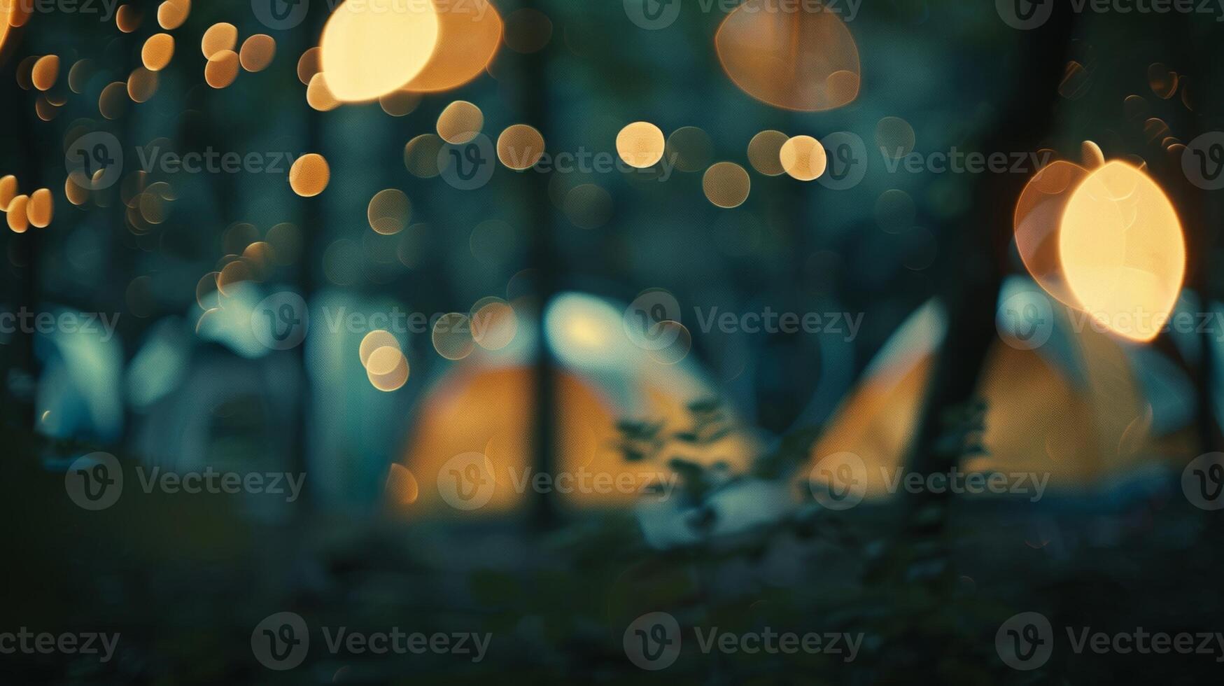 Defocused glimpses of a campsite with indistinct shapes of tents and a subtle firelight shining through photo