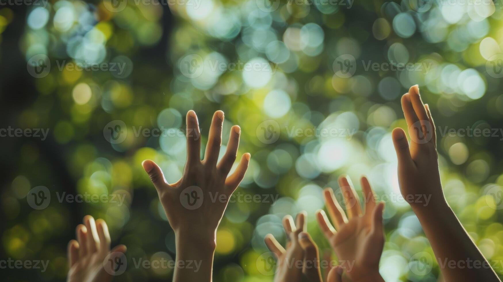Blurred hands reach up towards the sky moving in unison with the beat of the music photo