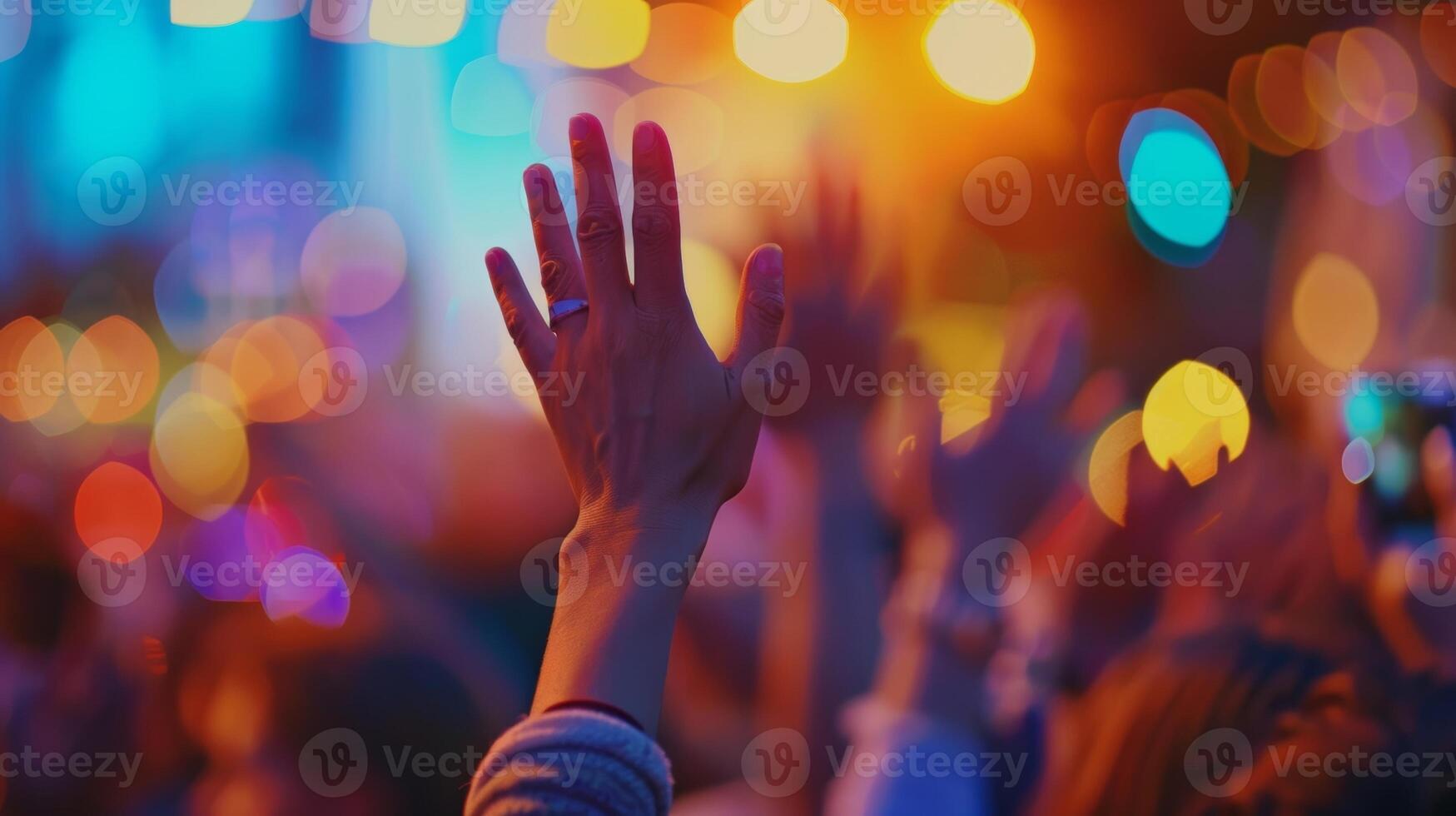 Even in defocused form the hands raised in praise at the outdoor church service exude a sense of devotion and connection photo