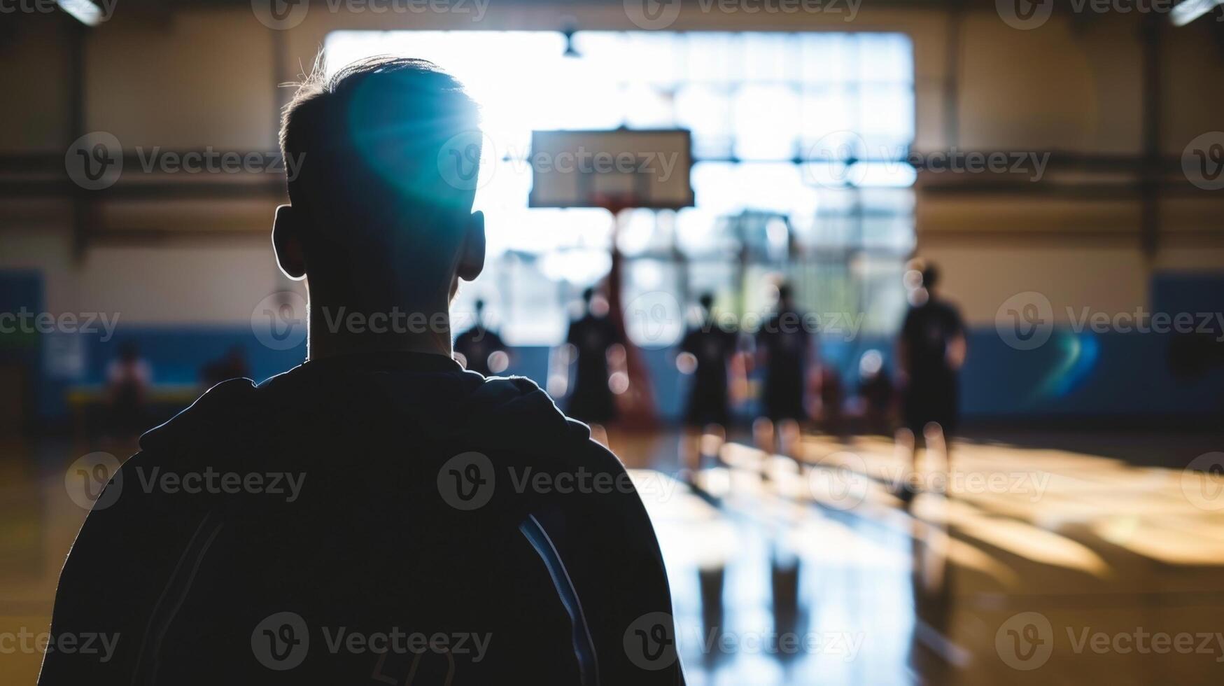 The blurry outline of a coach barking instructions to their team in preparation for a game photo