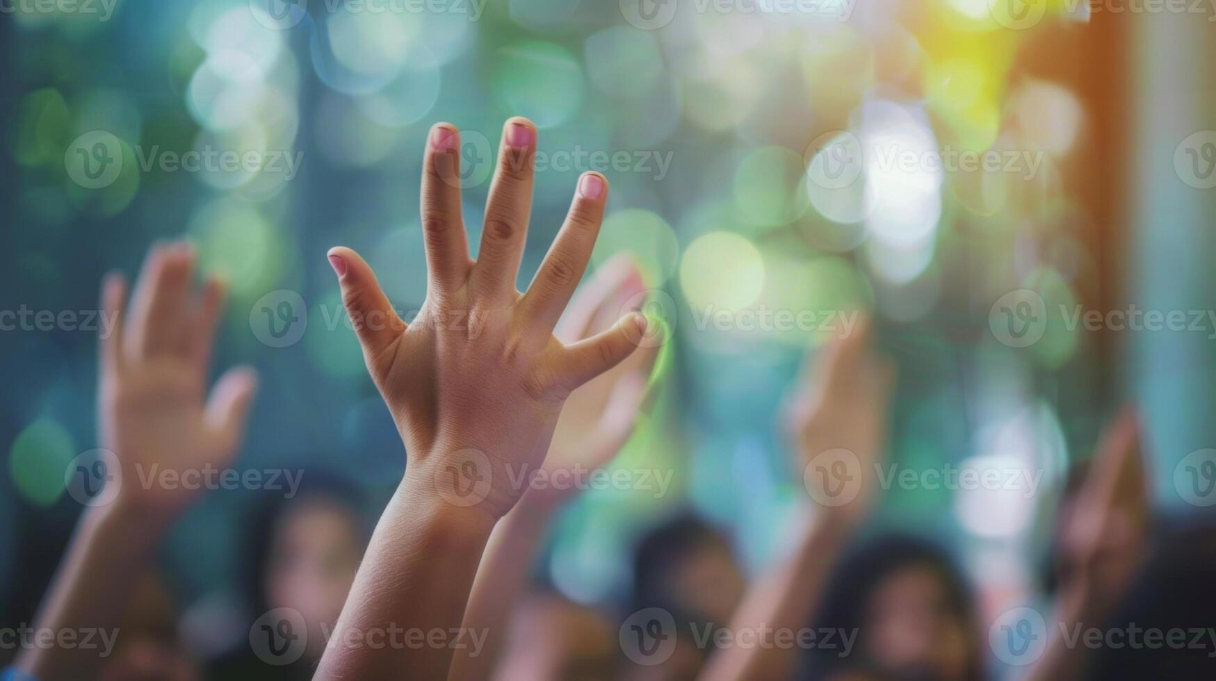 Defocused small hands raised eagerly ready to answer the storytellers questions photo