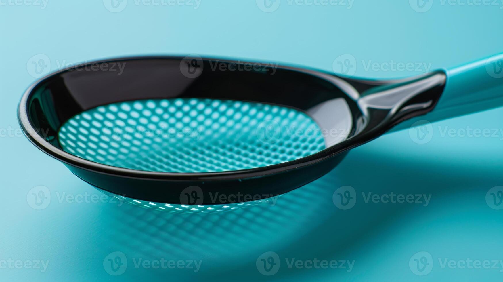 A longhandled scoop with a mesh basket for scooping up small pieces of litter photo