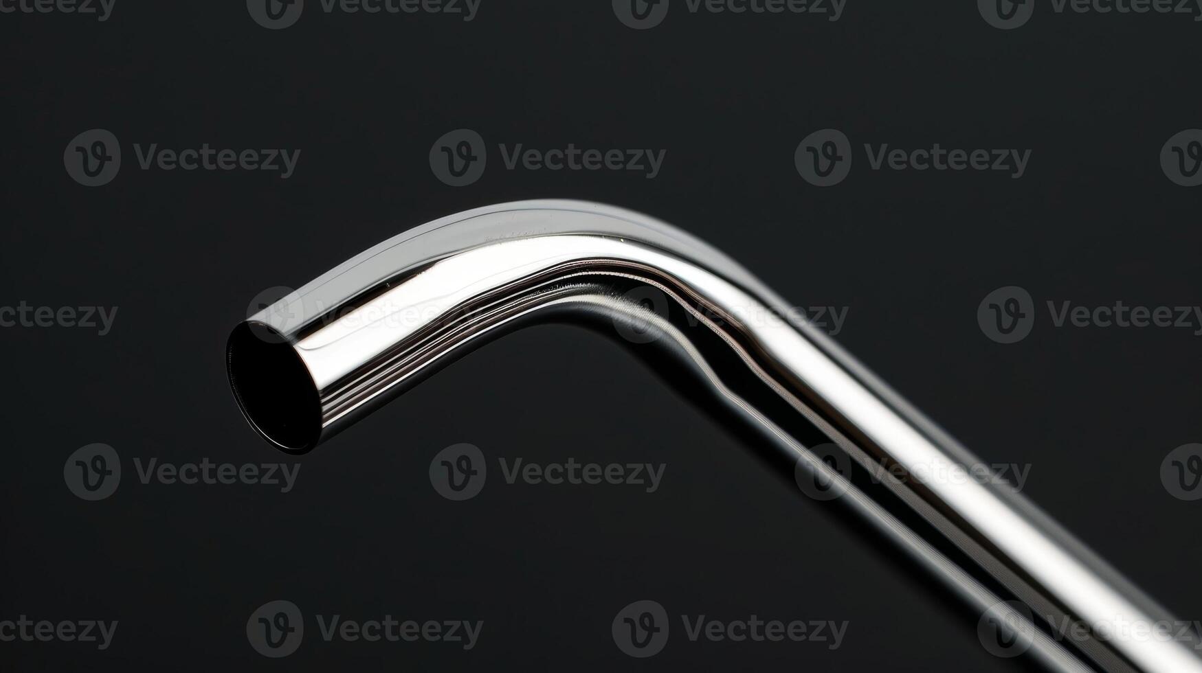 A closeup of a curved metal straw showcasing its smooth and shiny surface photo