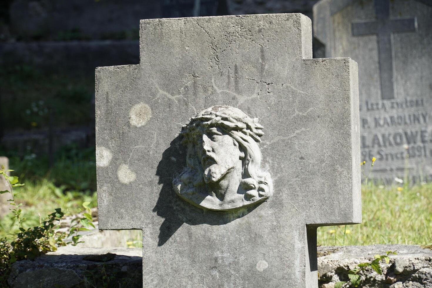 Vilnius, Lithuania - September 7th 2023 - Grave with face of Jesus at Rasos Cemetery photo