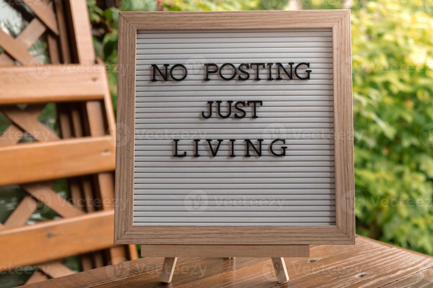 NO POSTING JUST LIVING text on letter board on background of greenery garden. Concept of social media technology detox. Farmcore nature core sustainable slow life photo