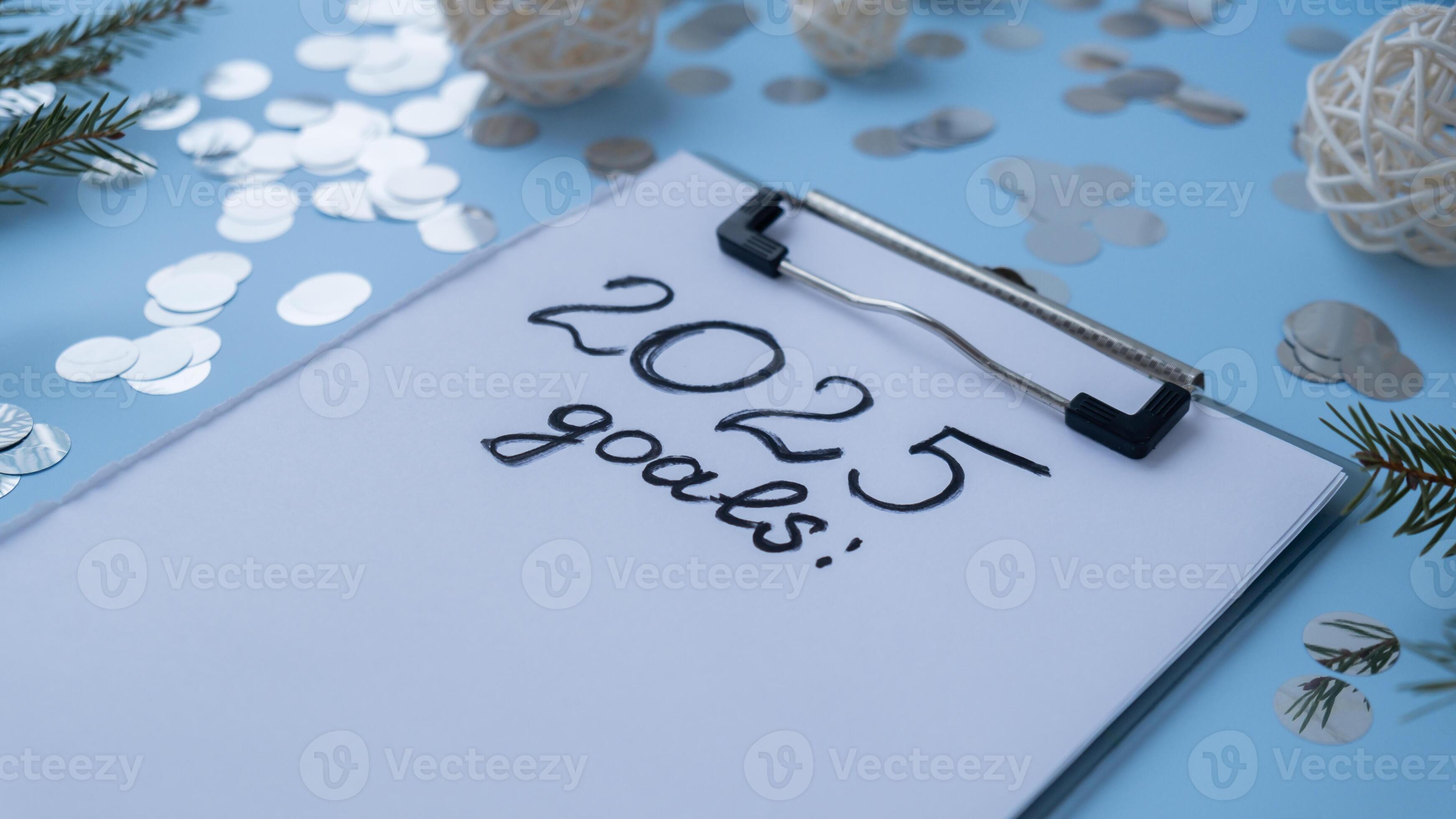 Handwritten 2025 GOALS new year resolutions aims goals on paper notepad