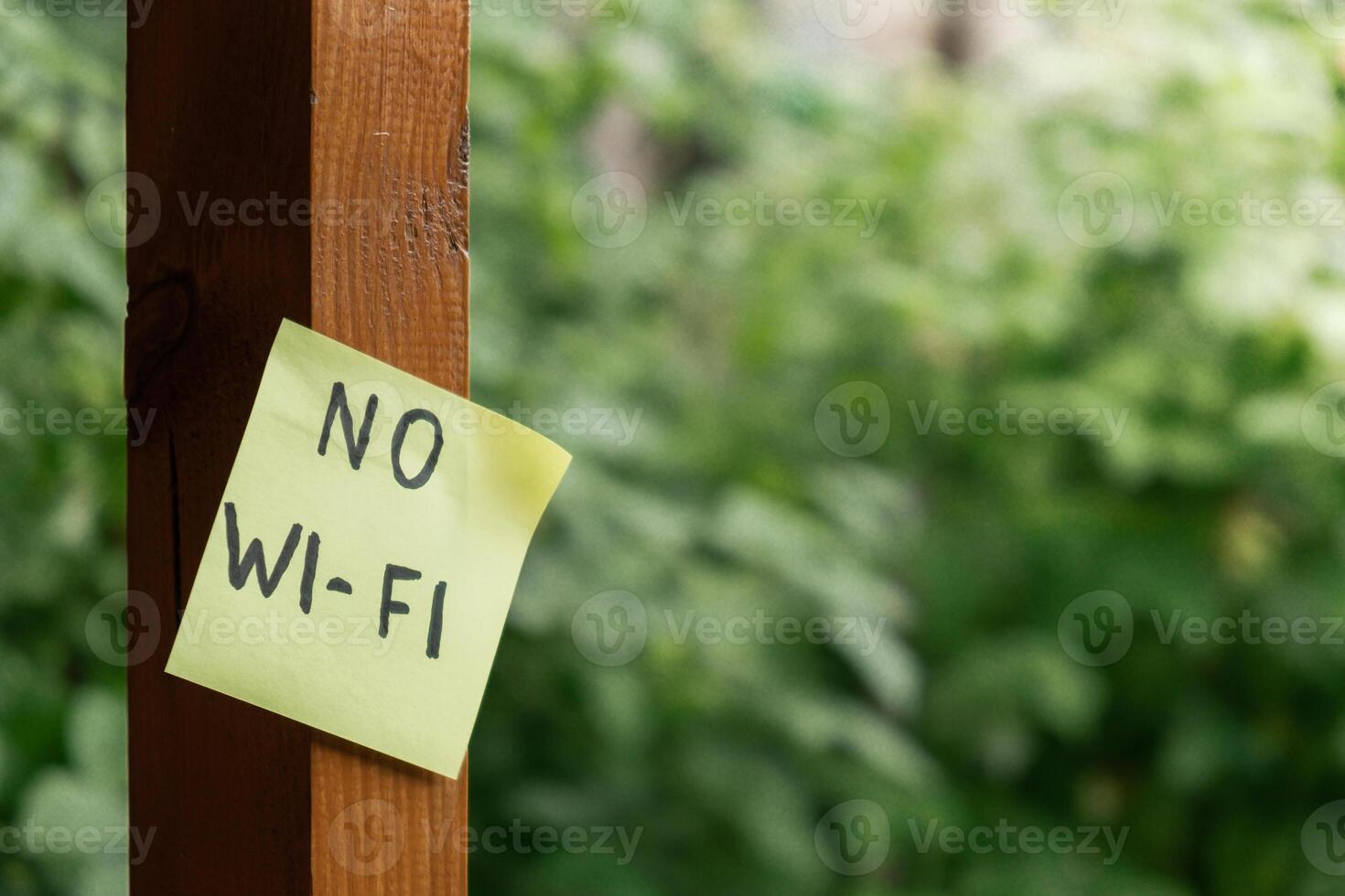 NO WI FI text on paper note on background of greenery garden wooden alcove outdoor. Concept of social media technology detox. Farmcore nature core sustainable slow life photo
