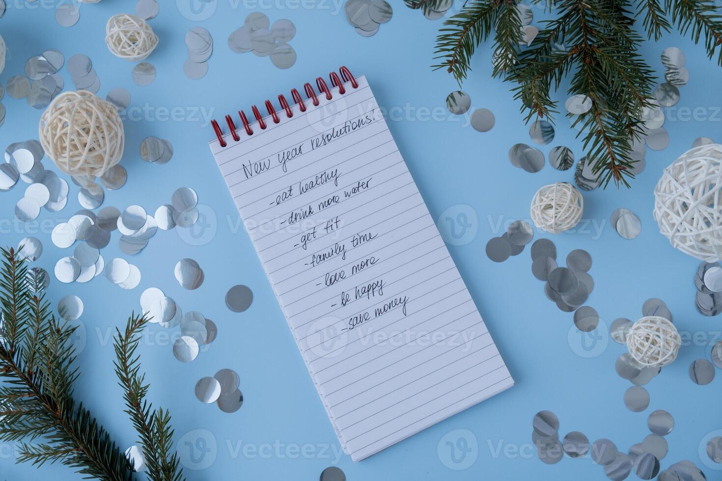 New year's resolutions on paper note with Christmas decor. Making promises for new year, setting goals. Creating dream vision board motivation photo