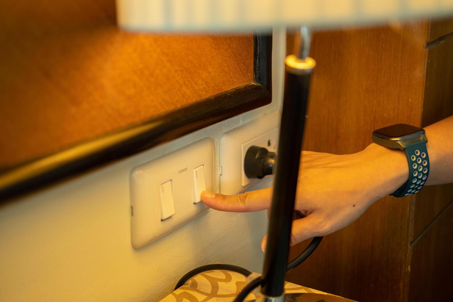 A woman's hand is pulling an electrical plug to turn off a switch. to save energy photo