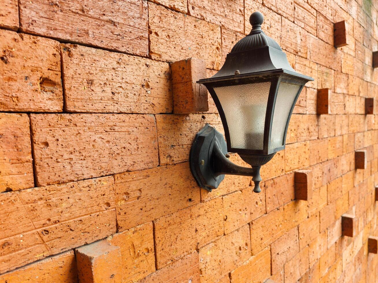 lamps on neatly arranged brick walls photo