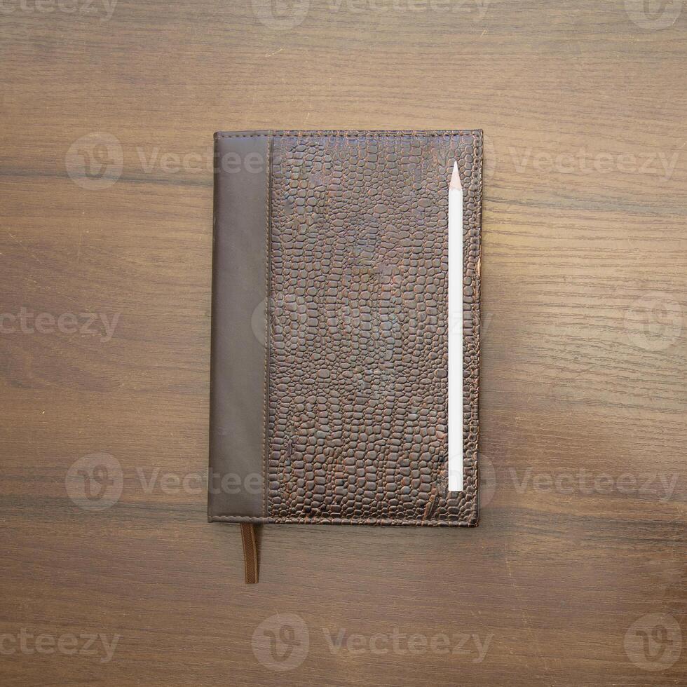 Notebook and pencil on a beautiful background in a large photo studio
