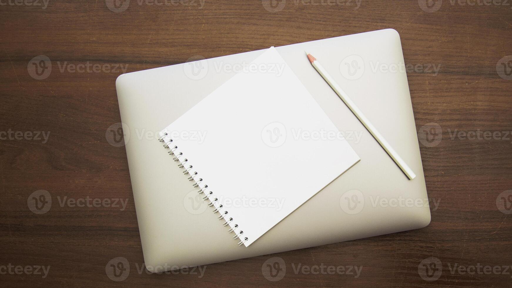 Notebook and pencil on a beautiful background in a large photo studio