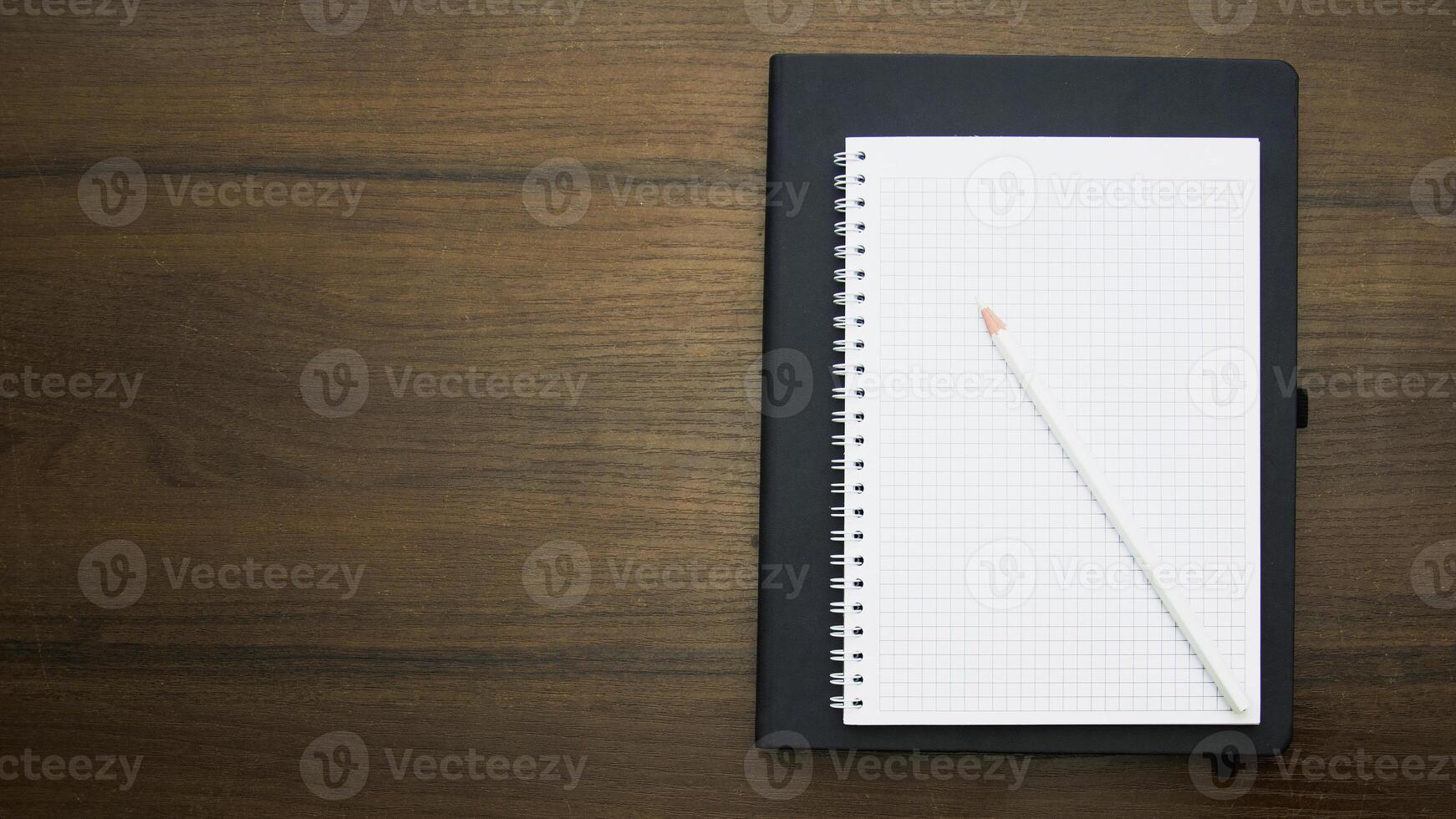 Notebook and pencil on a beautiful background in a large photo studio