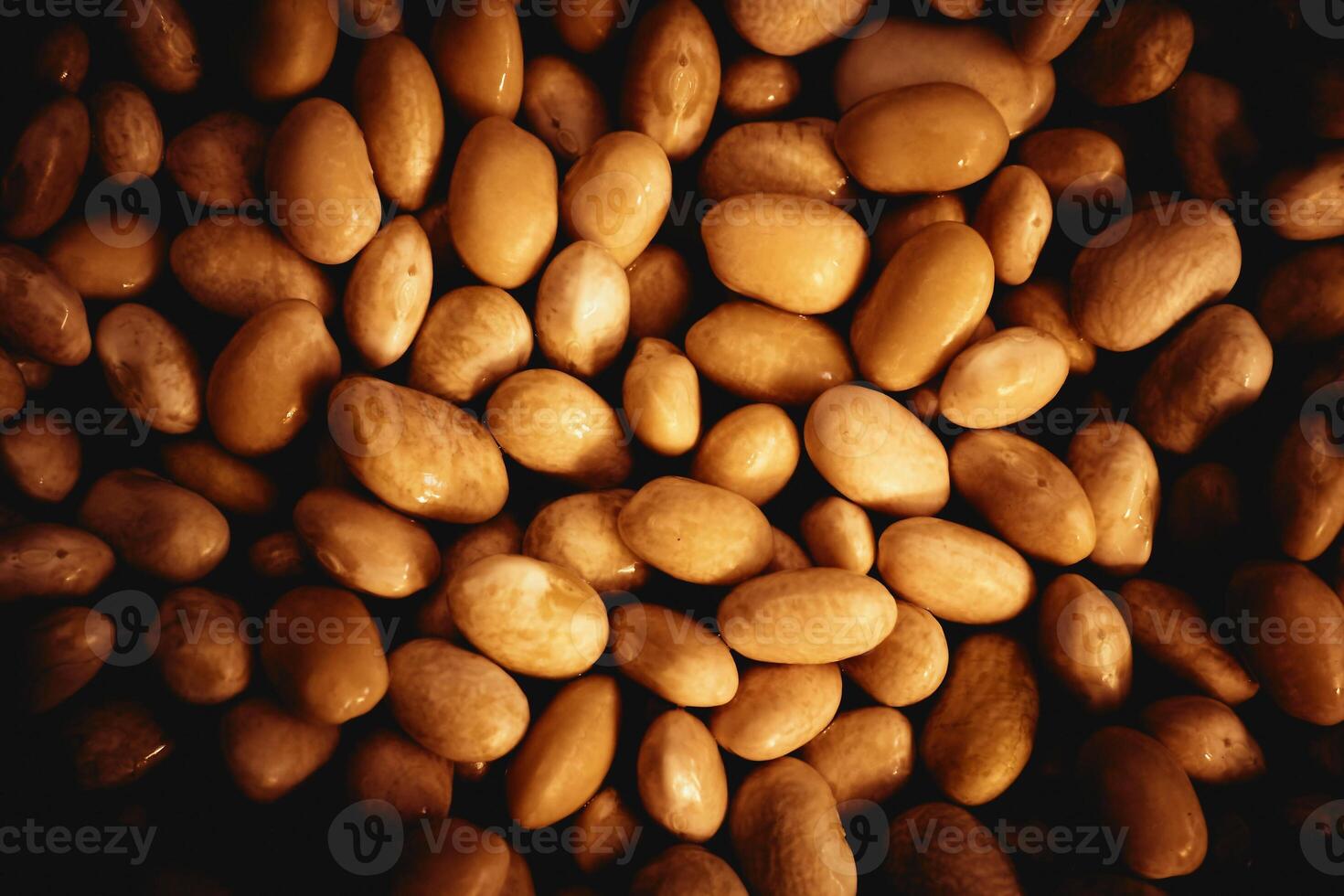 Brown beans haricot for making stews. Sweet candies, pebbles, backdrop photo