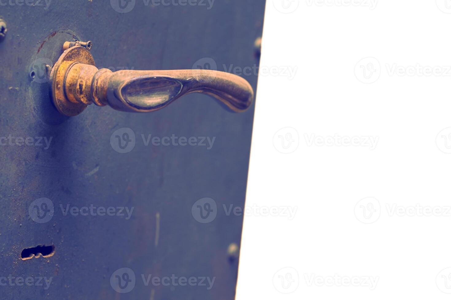 Copper brass handle on a metal gray blue door.Place for text photo