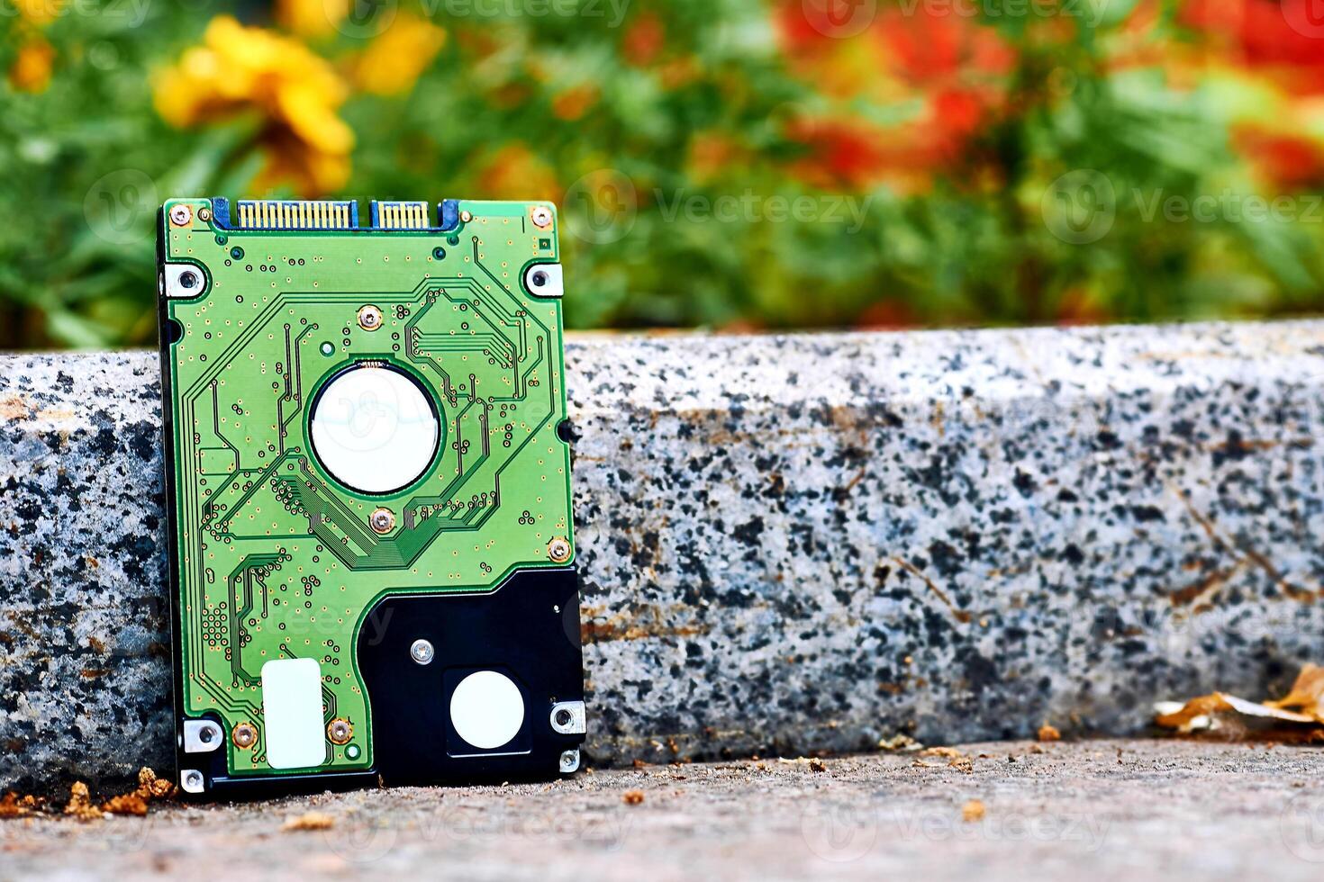 Green Internal hard drive for storing information on sidewalk photo