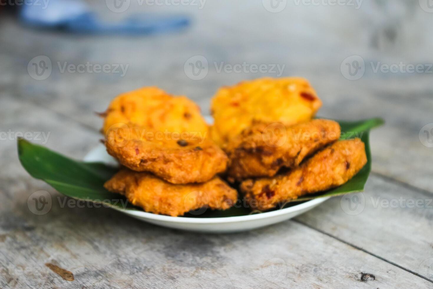 a pile of tofu fritters or fried tofu bread on a leaf plate. Made from a mixture mashed tofu, a little tapioca flour, green onions, eggs, salt and pepper. Crispy on the outside, soft on the inside photo