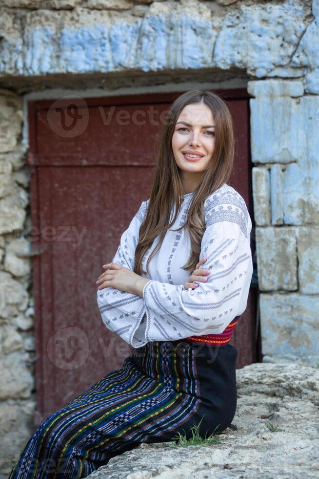 Beautiful traditional costume from Republic of Moldova. Young girl wearing Romanian traditional blouse. photo