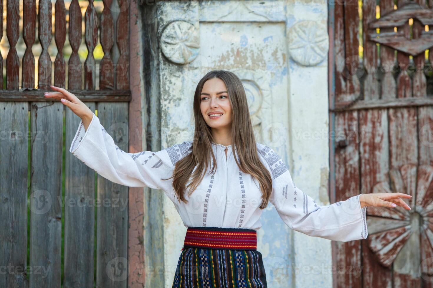 young girl wearing Romanian traditional blouse in the country. Authentic national costume of the Romanian tradition. photo
