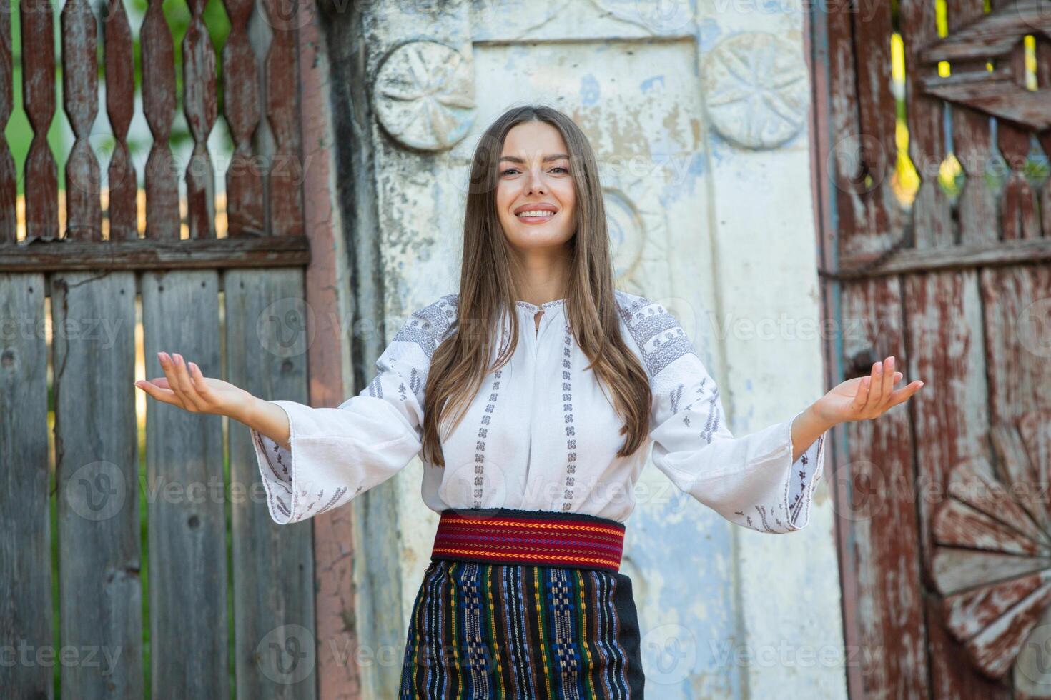 young girl wearing Romanian traditional blouse in the country. Authentic national costume of the Romanian tradition. photo