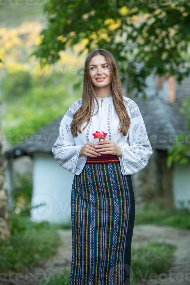 Beautiful traditional costume from Republic of Moldova. Young girl wearing Romanian traditional blouse. photo