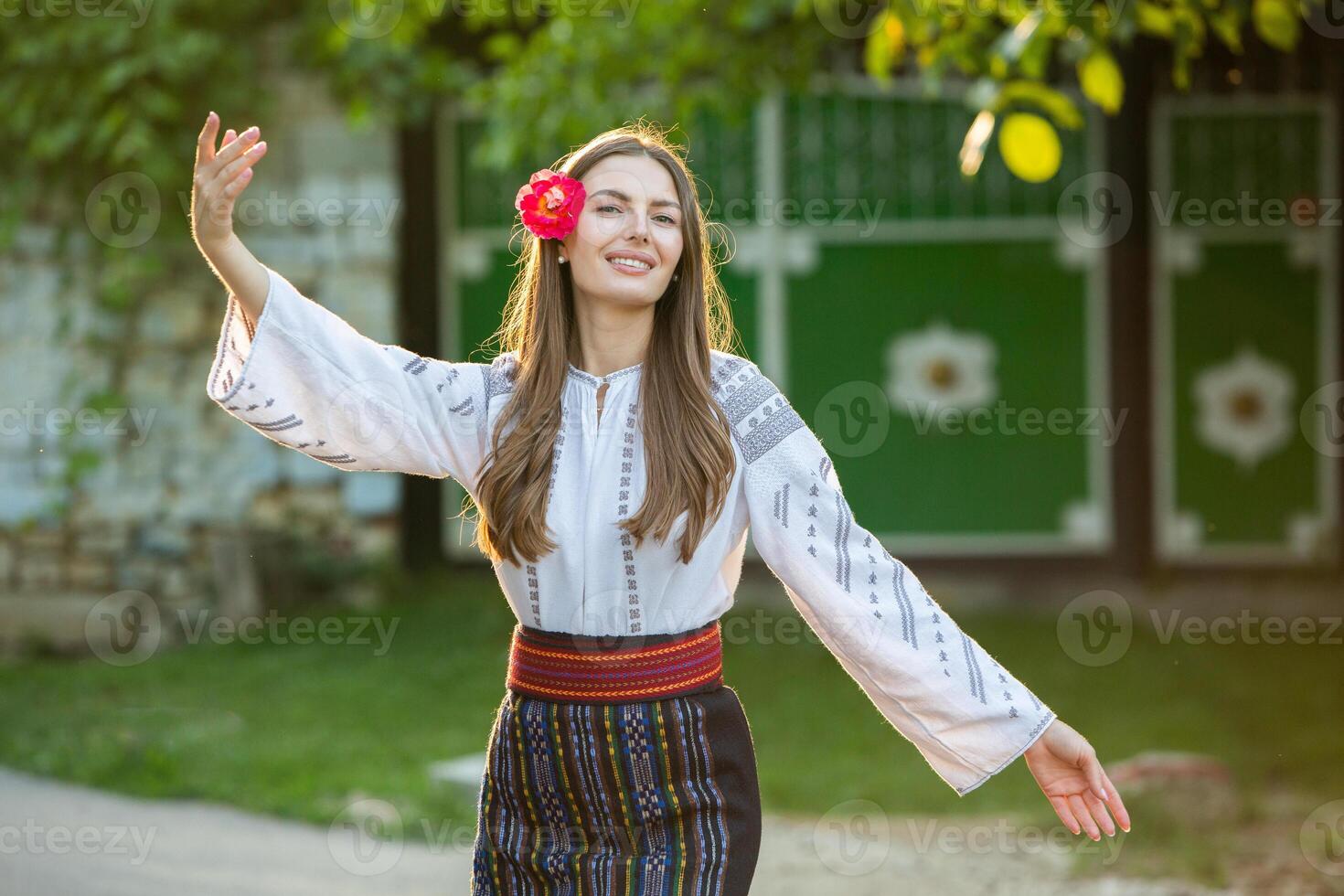 young girl wearing Romanian traditional blouse in the country. Authentic national costume of the Romanian tradition. photo