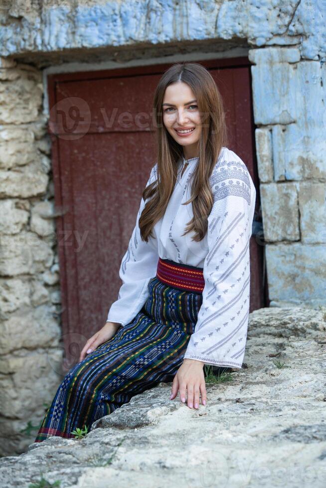 Beautiful traditional costume from Republic of Moldova. Young girl wearing Romanian traditional blouse. photo