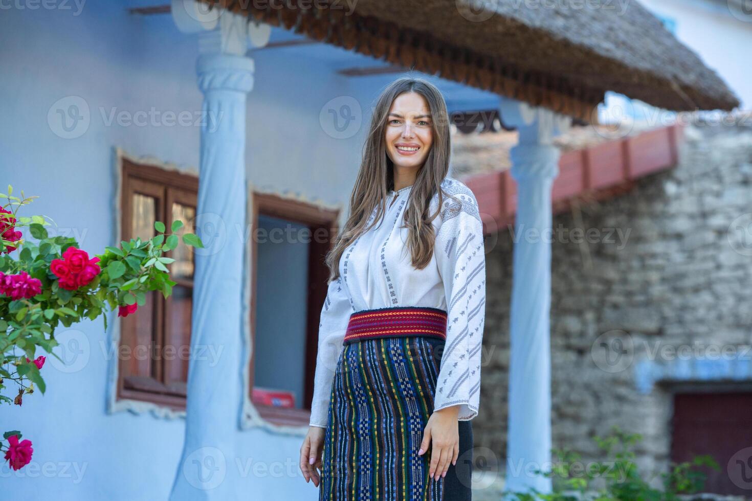 young girl wearing Romanian traditional blouse in the country. Authentic national costume of the Romanian tradition. photo