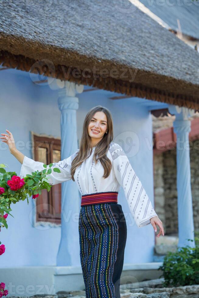 Beautiful traditional costume from Republic of Moldova. Young girl wearing Romanian traditional blouse. photo