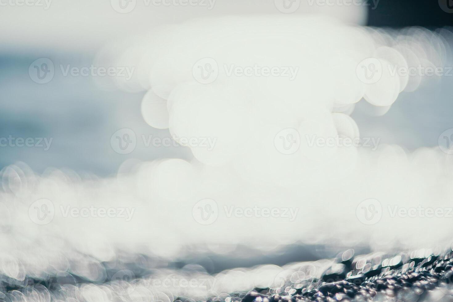 Abstract nature summer ocean sunset sea background. Small waves on water surface in motion blur with bokeh lights from sunrise. Holiday, vacation and recreational background concept. photo