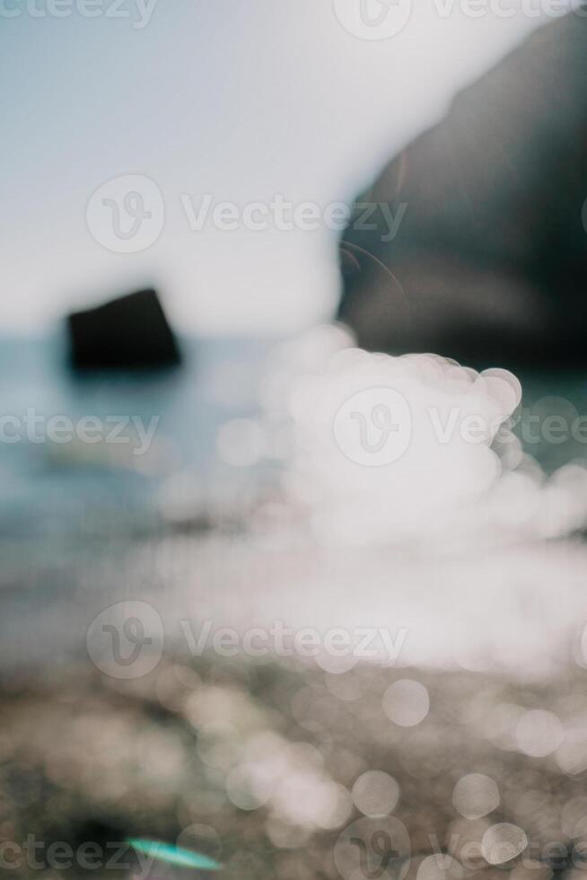 Abstract nature summer ocean sunset sea background. Small waves on water surface in motion blur with bokeh lights from sunrise. Holiday, vacation and recreational background concept. photo