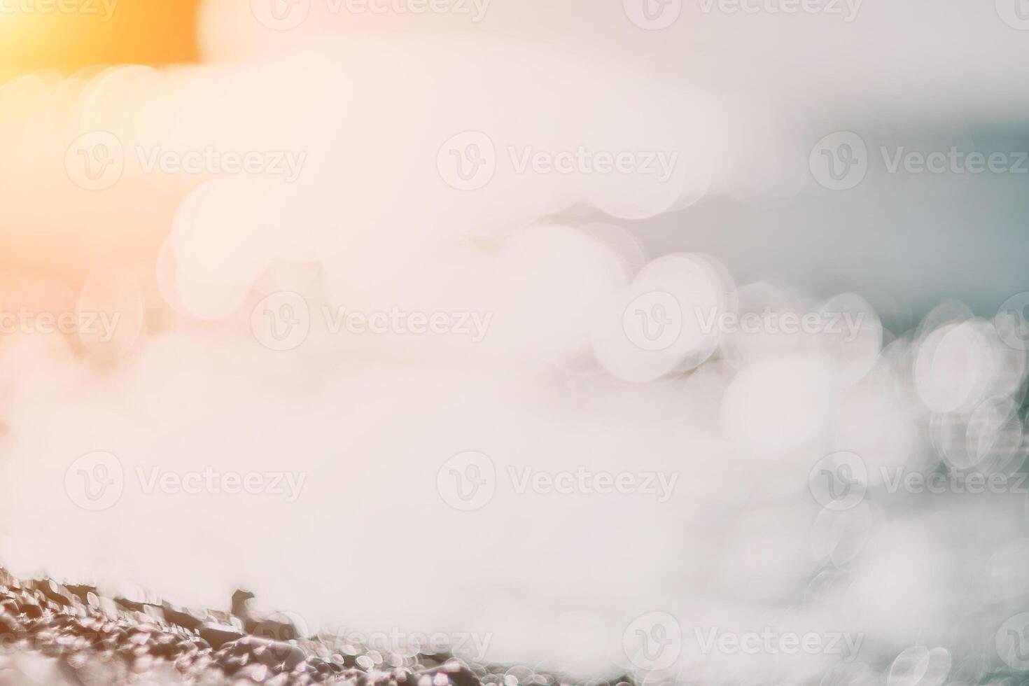 Blurred golden sea at sunset. The sun reflects and sparkles on the waves with bokeh, illuminating the golden sea. Holiday recreation concept. Abstract nautical summer ocean sunset nature background. photo